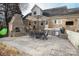 Outdoor patio area with a brick fireplace, outdoor kitchen, and dining table is perfect for entertaining at 6800 Newhall Rd, Charlotte, NC 28270