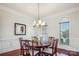 Elegant dining room features wood floors, crown molding, and a stylish chandelier at 7007 Dowington Dr, Charlotte, NC 28277