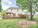 A wooden deck with backyard showing a gazebo and a hot tub at 712 Georgie St, Troutman, NC 28166