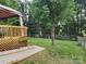 Spacious backyard featuring a gazebo on a deck and a large, mature tree at 712 Georgie St, Troutman, NC 28166
