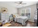 Bright bedroom featuring wood floors, a ceiling fan, a window and cheerful decor at 712 Georgie St, Troutman, NC 28166