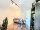Bright bonus room featuring hardwood floors, neutral paint, modern lighting, and a comfortable seating area at 712 Georgie St, Troutman, NC 28166