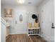 Inviting foyer with wood flooring, a decorative bench, and a front door with an oval window at 712 Georgie St, Troutman, NC 28166