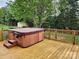 View of a wooden deck with a hot tub featuring steps for easy access at 712 Georgie St, Troutman, NC 28166