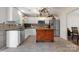 Bright kitchen with white cabinets, stainless steel appliances, granite countertops, and a wooden island at 712 Georgie St, Troutman, NC 28166