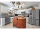 Well-lit kitchen featuring granite counters, tiled floors, wooden island, and stainless steel appliances at 712 Georgie St, Troutman, NC 28166