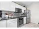 Modern kitchen with stainless steel appliances, granite countertops, and stylish backsplash at 712 Georgie St, Troutman, NC 28166