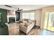 Cozy living room featuring a fireplace, a large sectional sofa, and sliding doors to the deck at 712 Georgie St, Troutman, NC 28166