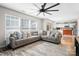 Open-concept living room with natural light, large sectional, and view of the kitchen with a wooden island at 712 Georgie St, Troutman, NC 28166