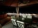 Night view of a relaxing outdoor dining area featuring a gazebo and table with four chairs at 712 Georgie St, Troutman, NC 28166