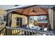 Cozy outdoor seating area with a gazebo, table, chairs, and a hot tub in the background at 712 Georgie St, Troutman, NC 28166