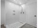 Walk-in shower featuring a rainfall showerhead, built-in niches, and mosaic flooring at 712 Georgie St, Troutman, NC 28166