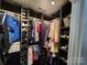 Well-organized walk-in closet with dark wood shelving and rods offering ample storage at 712 Georgie St, Troutman, NC 28166