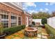 Brick patio with fire pit and lush landscaping at 7905 Oratorio Pl, Charlotte, NC 28270