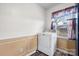 Bright laundry area featuring a modern washing machine, wood-look floors, and natural light at 906 16Th Nw St, Conover, NC 28613