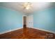 Bedroom with light blue walls, hardwood floors and access to bathroom at 913 S Franklin St, China Grove, NC 28023