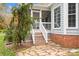 Back porch stairs lead to a backyard with stone pavers and a mature weeping tree at 10015 Lattice Ct, Charlotte, NC 28269