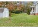 Well-manicured backyard with a storage shed and access to the home's screened porch at 10015 Lattice Ct, Charlotte, NC 28269