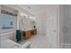 Bright bathroom featuring a soaking tub, double sink vanity, and a separate glass enclosed shower at 10015 Lattice Ct, Charlotte, NC 28269