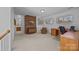 Bonus room featuring a brick accent wall, multiple windows and a view of an adjacent bathroom at 10015 Lattice Ct, Charlotte, NC 28269