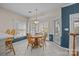 Sunlit breakfast nook featuring a round wooden table with views to the backyard at 10015 Lattice Ct, Charlotte, NC 28269