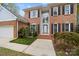 The front entrance features a towering arched window and decorative shrubs and bushes at 10015 Lattice Ct, Charlotte, NC 28269