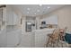 Modern kitchen with white cabinetry, stainless steel appliances, and a breakfast bar at 10015 Lattice Ct, Charlotte, NC 28269