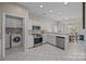 Open kitchen featuring stainless appliances, white cabinets and an adjacent breakfast nook at 10015 Lattice Ct, Charlotte, NC 28269