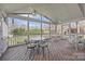 Open screened porch with a table, seating, ceiling fan, and views of the backyard at 10015 Lattice Ct, Charlotte, NC 28269