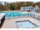 Beautiful community swimming pool with lap lanes and a separate kiddie pool surrounded by trees at 10015 Lattice Ct, Charlotte, NC 28269