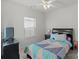 Bedroom with ceiling fan, TV, and window coverings at 10356 Black Locust Ln, Harrisburg, NC 28215