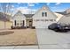 Craftsman style home with two-car garage and landscaped lawn at 10356 Black Locust Ln, Harrisburg, NC 28215