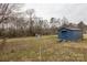 Backyard with two blue storage sheds and plenty of grass at 1221 S Myrtle School Rd, Gastonia, NC 28052