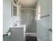 Nicely updated bathroom with a glass shower, modern vanity, updated fixture, and light color palette at 1221 S Myrtle School Rd, Gastonia, NC 28052