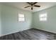 Bedroom with two windows letting in natural light and dark wood-look flooring at 1221 S Myrtle School Rd, Gastonia, NC 28052