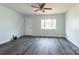 Spacious living room with new floors, neutral paint, ceiling fan, and a large window for natural light at 1221 S Myrtle School Rd, Gastonia, NC 28052