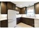 White appliances and dark wood cabinets in this updated kitchen at 1223 India Hook Rd, Rock Hill, SC 29732