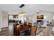 Dining area with dark wood table and chairs, open to the living room and kitchen at 130 Portman Ln, Statesville, NC 28625