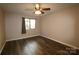 Simple bedroom with dark hardwood floors and ceiling fan at 1419 Riverwood Ct, Rock Hill, SC 29732