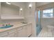 Bathroom with light blue tile, double vanity, and shower/tub combo at 1491 Black Hwy, York, SC 29745