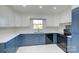 Updated kitchen boasts white and blue cabinetry and quartz countertops at 1491 Black Hwy, York, SC 29745