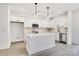 Modern kitchen with white cabinets, quartz countertops, and a large island at 1510 Nectar Way, Kannapolis, NC 28027