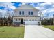 Two-story house with light beige siding, stone accents, and a two-car garage at 1520 Nectar Way, Kannapolis, NC 28027