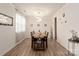 Dining room with a wooden table, four chairs, and modern light fixture at 15209 Red Canoe Way, Charlotte, NC 28278