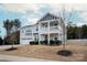 Two-story house with gray siding, a balcony, and a two-car garage at 15209 Red Canoe Way, Charlotte, NC 28278