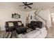 Living room with leather sofas, a ceiling fan, and an open floor plan at 15209 Red Canoe Way, Charlotte, NC 28278