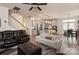 Living room with leather sofas, a ceiling fan, and an open floor plan at 15209 Red Canoe Way, Charlotte, NC 28278