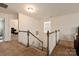 Upstairs hallway with a split staircase and carpeted flooring at 15209 Red Canoe Way, Charlotte, NC 28278