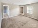 Spacious carpeted bedroom with neutral walls and ample natural light at 15305 Colonial Park Dr, Huntersville, NC 28078