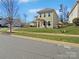 Two-story house with light green siding, a manicured lawn, and a sidewalk at 15305 Colonial Park Dr, Huntersville, NC 28078